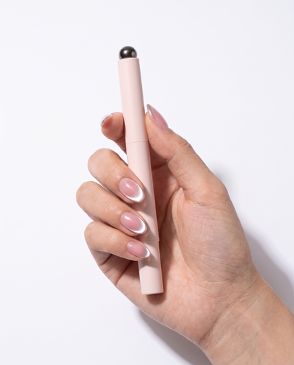 Lumia cat eye gel pen held in a hand with finished cat eye nails