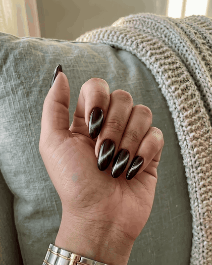 Cat eye nails catching the light on the couch